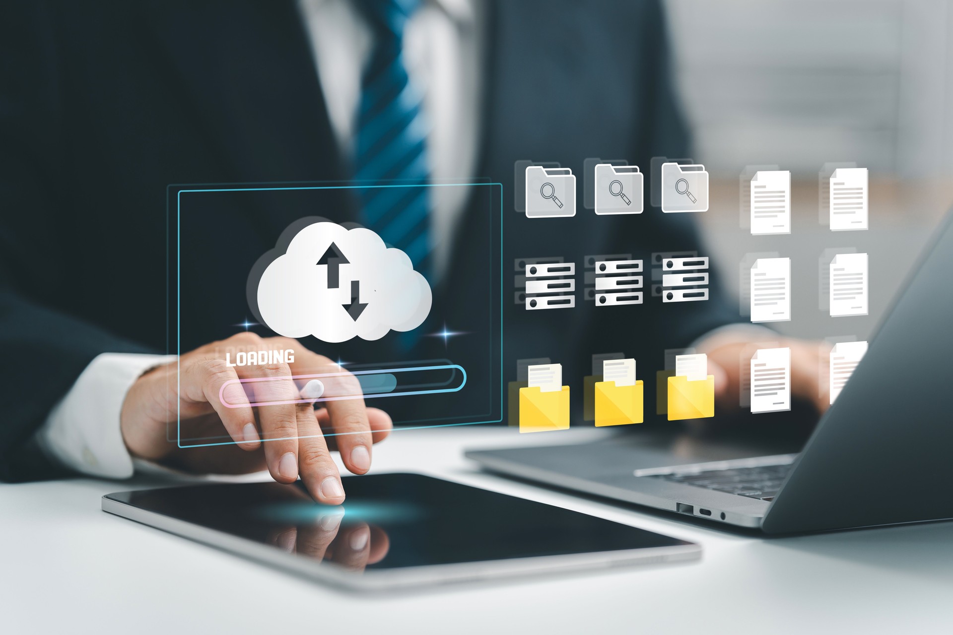 Cloud computing concept. Businessman uses a tablet and laptop with digital cloud storage and data icons, suggesting cloud-based data management. upload and download. digital service. data center.